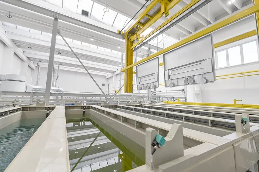 Metal part above vats with liquid
