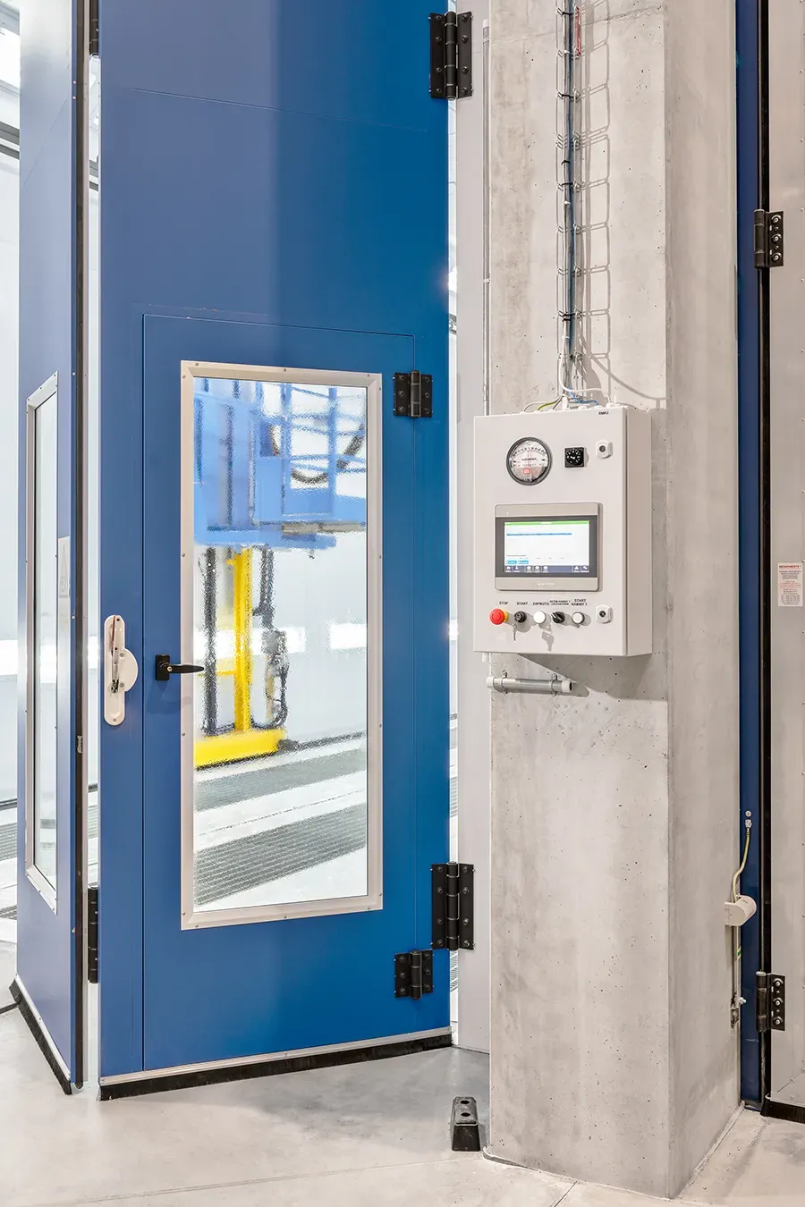 Coating booth panel with doors in background