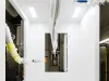 Metal part being coated by robots