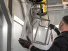 Metal parts being cleaned with pressurised air