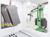 Metal parts on a conveyor with a coating robot arm