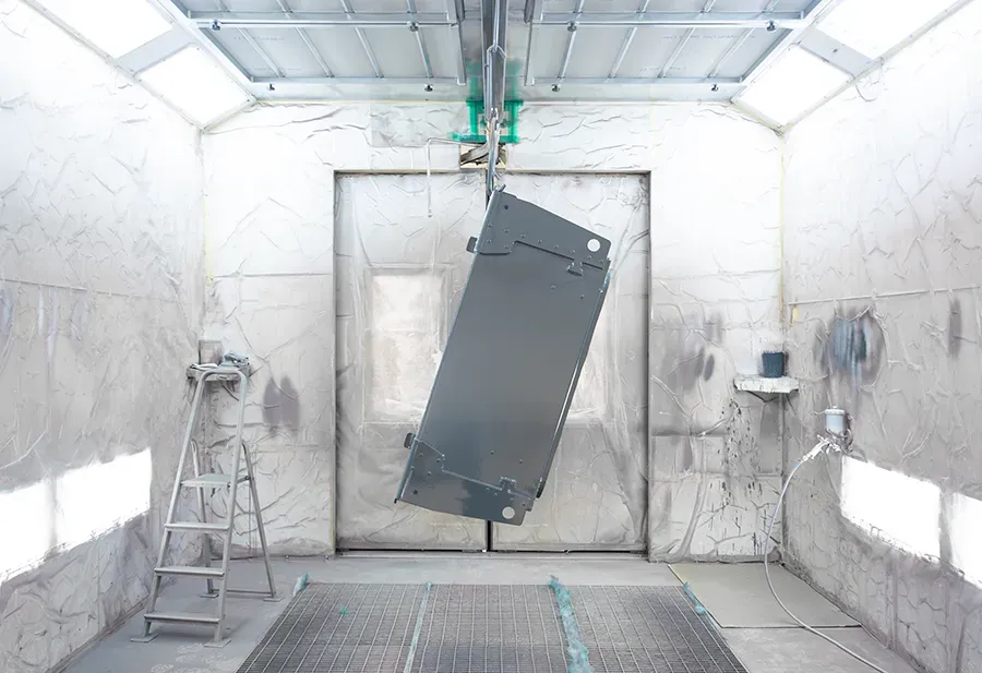 Coated metal part inside coating booth